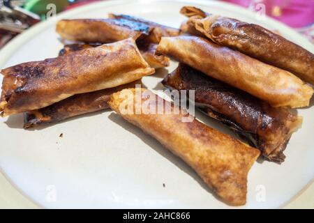Turon, a popular Filipino street food of bananas and jack fruit deep fried in spring roll pastry. Stock Photo