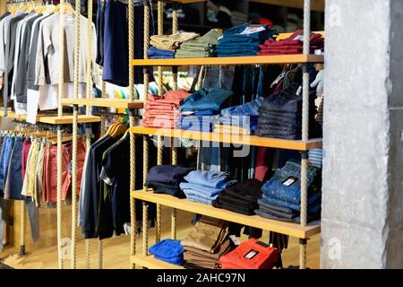 https://l450v.alamy.com/450v/2ahc97n/men-clothing-shop-fashionable-stylish-casual-clothes-on-hangers-and-shelves-in-apparel-store-2ahc97n.jpg