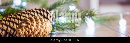 Christmas Decoration Banner - Snowy Pine Cones On Fir Branch With Christmas Lights Stock Photo