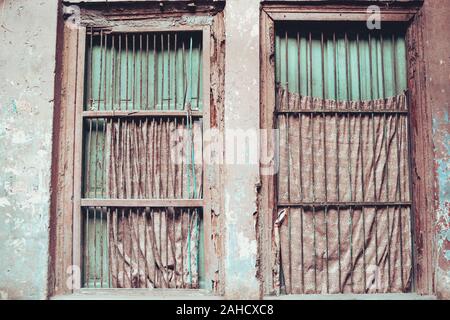 Windows with peeling paint and rust in Old Delhi India Stock Photo