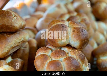 Assortment of baked bread on wooden table background in rustic bread bakery Stock Photo