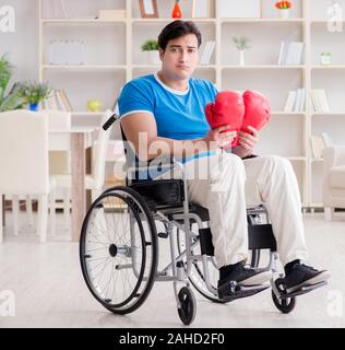 The disabled boxer at wheelchair recovering from injury Stock Photo