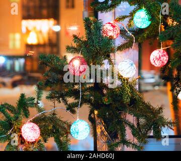 Christmas composition with fir branches and lanterns on the windowsill Stock Photo