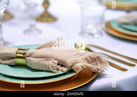 Simple and elegant wedding or festive table setting with napkin in close-up Stock Photo