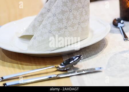 Simple and elegant wedding or festive table setting with napkin in close-up Stock Photo