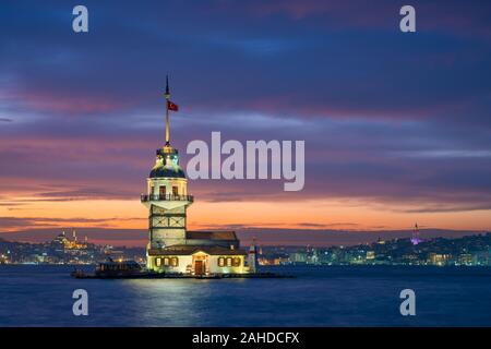 Maiden's Tower in Istanbul, Turkey at night with a mosque and Galata tower in the background Stock Photo