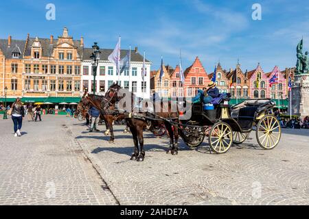 Horse carriages at the Market Square (Markt) in Bruges, Belgium Stock Photo