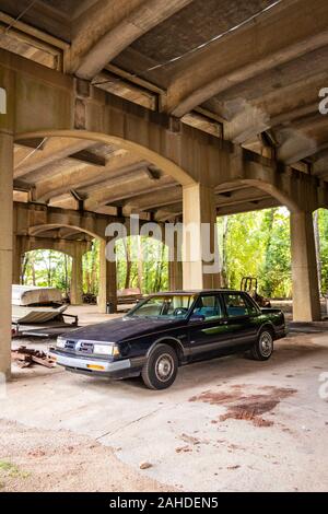 1991 Oldsmobile Eighty Eight Royale sedan parked under 1st Av overpass at the Sloss Furnace National Historic Landmark in Birmingham AL Stock Photo