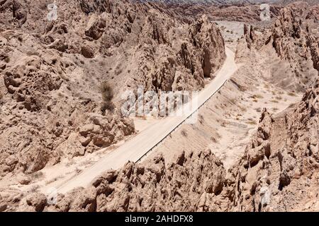 View of the gravel surfaced route 40 road passing through the Quebrada de las Flechas mountain region, just north of the town of Cafayate, Argentina. Stock Photo