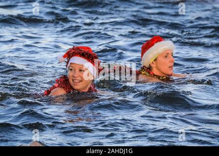 Christmas Day swimmers in Santa hat swim in cold open water at the swimming race for the 'Peter Pan Cup', Serpentine Swimming Club, Hyde Park, London Stock Photo