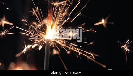 Firework sparkler burning on black background. Merry Christmas and happy new year celebration Stock Photo