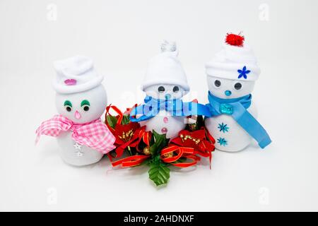 Three handmade snowmen made from white socks. Stock Photo