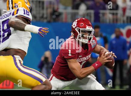 Atlanta, United States. 28th Dec, 2019. Oklahoma Sooners quarterback Jalen Hurts (1) tries to scramble away from LSU Tigers linebacker K'Lavon Chaisson (18) during the first half of the Chick-fil-A Peach Bowl NCAA semifinal game at Mercedes-Benz Stadium in Atlanta, December 28, 2019. Photo by David Tulis/UPI Credit: UPI/Alamy Live News Stock Photo