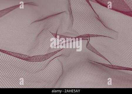 Beautiful close up of red tulle fabric with textile texture background Stock Photo
