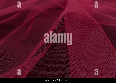 Beautiful close up of red tulle fabric with textile texture background Stock Photo