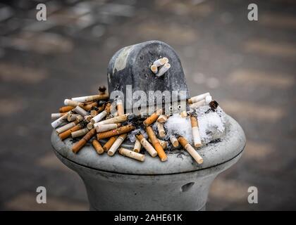 Cigarette butts in an outdoor ashtray, or smoking receptacle, Winnipeg, Manitoba, Canada. Stock Photo