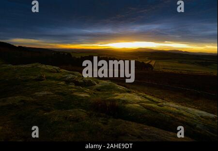 Sunset over the Cheviots viewed from above St Cuthbert's Cave in the Kyloe Hills near Belford, Northumberland, England Stock Photo