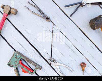 Old Worn Hand Tools Against Blue Wooden Background Stock Photo