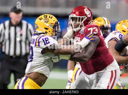 December 28, 2019: LSU linebacker K'Lavon Chaisson (18) and Oklahoma offensive lineman R.J. Proctor (73) battle at the line of scrimmage during NCAA Football game action between the Oklahoma Sooners and the LSU Tigers at Mercedes-Benz Stadium in Atlanta, Georgia. LSU defeated Oklahoma 63-28. John Mersits/CSM Stock Photo