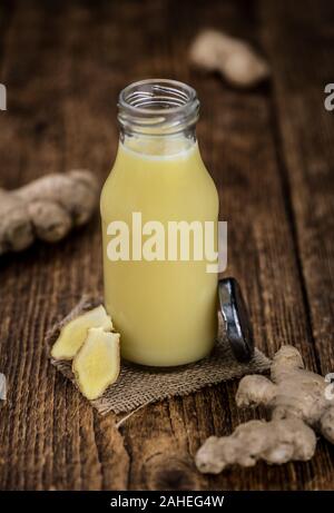 Healthy Ginger Sap on a wooden table as detailed close-up shot (selective focus) Stock Photo