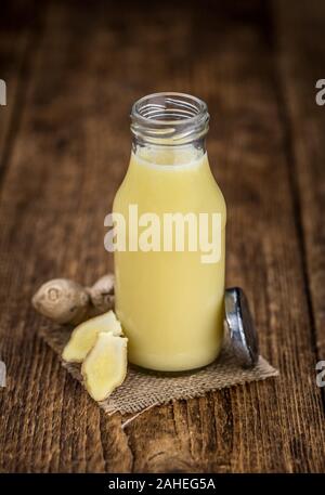 Healthy Ginger Sap on a wooden table as detailed close-up shot (selective focus) Stock Photo