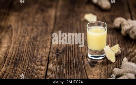 Healthy Ginger Sap on a wooden table as detailed close-up shot (selective focus) Stock Photo