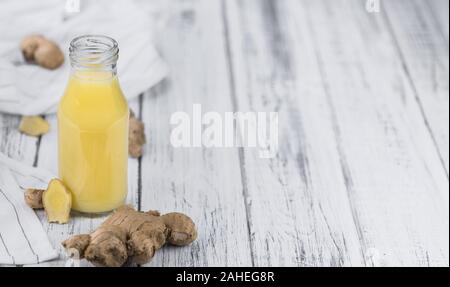 Healthy Ginger Sap on a wooden table as detailed close-up shot (selective focus) Stock Photo