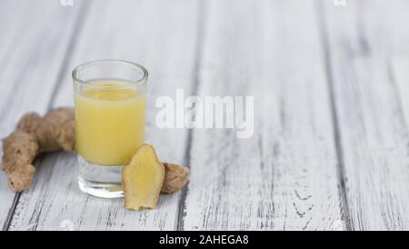 Healthy Ginger Sap on a wooden table as detailed close-up shot (selective focus) Stock Photo