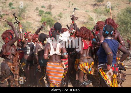 Hamer tribe, also hamar - Women dancing during 'bull jump': the most important ceremony for young men, the final test before passing into adulthood. Stock Photo