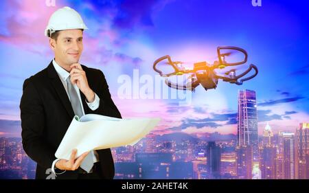 Drone operated by construction worker on building site Stock Photo