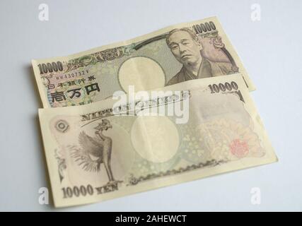 Ten thousand Japanese yen bank notes. Front and back. Isolated on white background. Stock Photo