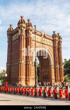 BARCELONA - JUNE 19, 2019: Pedestrians walking in front of the amazing Triumphal Arch, located in Barcelona, Spain, Europe Stock Photo