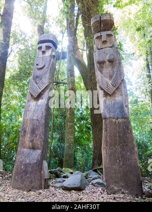 Wooden statue, in the middle of the Huilo Huilo Biological Reserve, regressing animals and Mapuche mystical characters from southern Chile. Los Ríos R Stock Photo