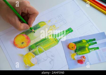 Man’s hand drawing an illustration with color pencils. Stock Photo