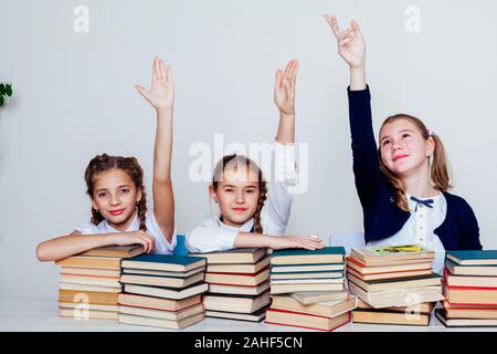 three girls at school in the classroom for books of knowledge Stock Photo