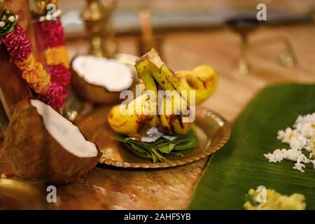 South Indian prayer items on a festival day, coconut with banana and betel leaf, Stock Photo