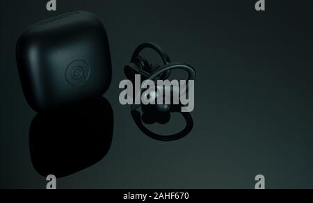 CHONBURI, THAILAND-DECEMBER 26, 2019 : Powerbeats Pro - Totally Wireless Earphones - Black and charging case. Workout earphones on dark background. Ap Stock Photo