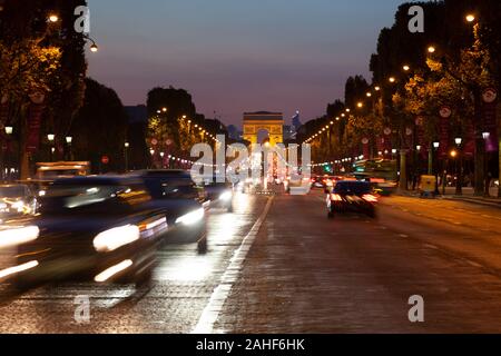 Arc de triomphe at the Champs-Elysees with heavy traffic at night, Paris Stock Photo