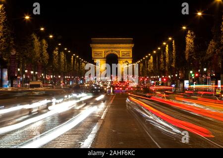 Arc de triomphe at the Champs-Elysees with heavy traffic at night, Paris Stock Photo