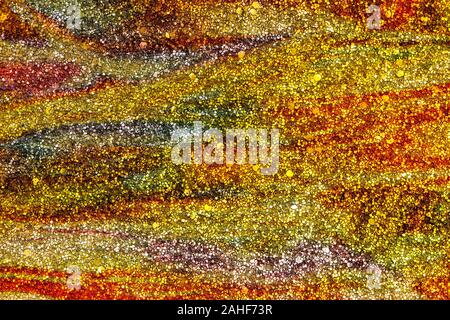 Abstract textured background of gold and orange glitter swirls Stock Photo