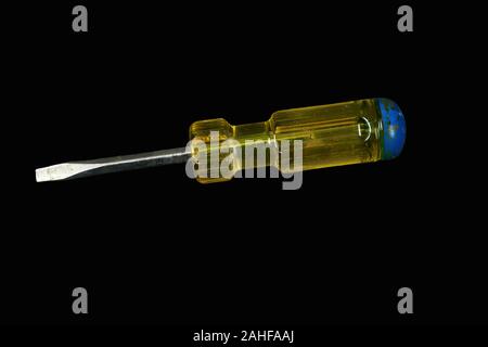 Screwdriver with a yellow and blue handle on a black background Stock Photo