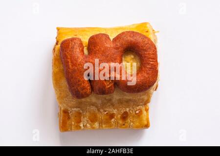 M&S Handcrafted Sausage Roll isolated on white background - Ho - looking down on from above Stock Photo