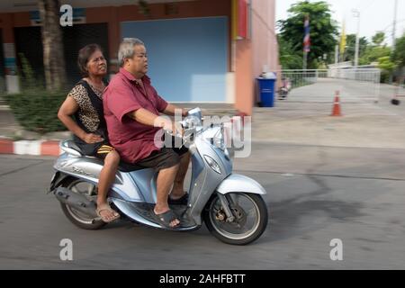 SAMUT PRAKAN, THAILAND, JUN 03 2019, Older couple rides in a motorbike. Scooter with pair on city street. Stock Photo