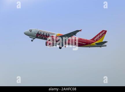 BANGKOK, THAILAND, JUN 03 2019, VietJet Air Airlines plane flies in the blue sky. The Vietnamese plane takes off and pull-in the chassis. Stock Photo