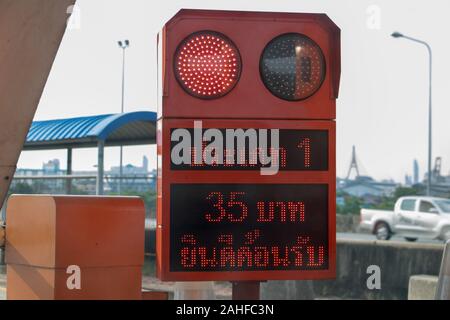 BANGKOK, THAILAND, JUN 03 2019, Semaphore at the gate of motorway entrance. Signboard on motorway exit with red traffic light. A fee to use the expres Stock Photo