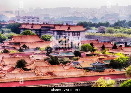 The pavilion of rain and flowers rising above the forbidden city in Beijing China on a hazy summer day. Stock Photo