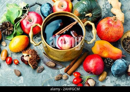 Alcoholic fruit drink sangria.Red wine and autumn fruits on the table. Stock Photo