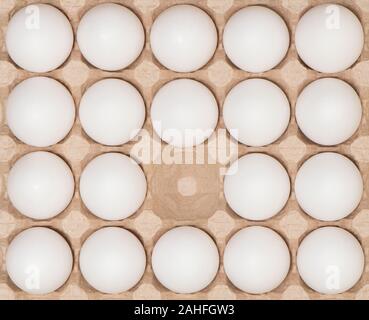 White chicken eggs in the carton box. Stock Photo