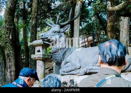 Deer fountain in Nara, Japan. The ancient capital is famous for its population of tame deers that lives in the cities' parks. Stock Photo