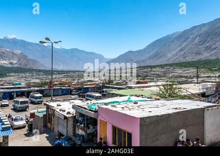 Gilgit Long Distance Intercity Bus Terminal with Minibuses waiting for Passengers on a Sunny Blue Sky Day Stock Photo